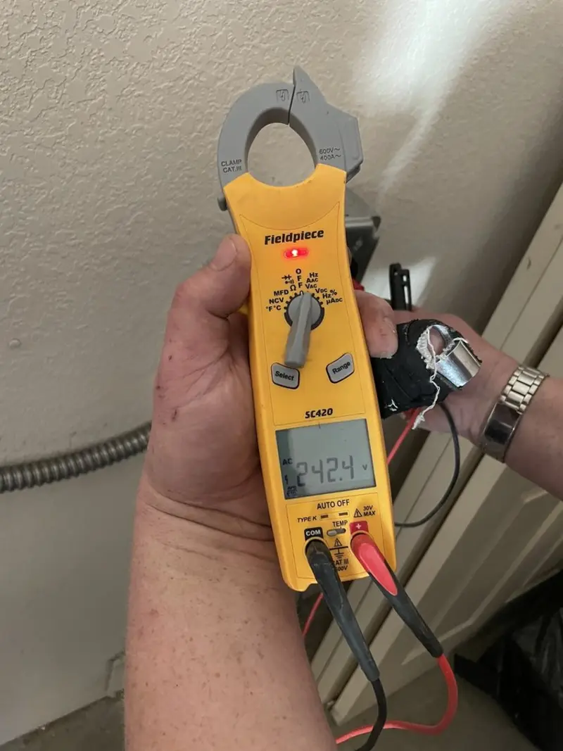 Voltage testing with clamp meter during Electrical Installation Services in Benson